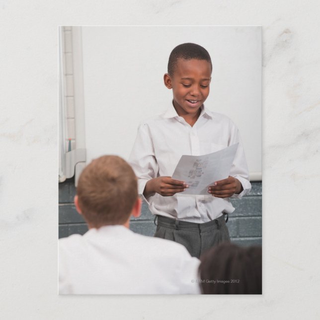 Boy standing in front of class reading in 2 postcard (Front)