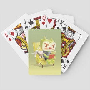 Boy with laptop sitting on the armchair playing cards