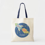 Boys Colourful Rocket Ship Space Galaxy and Name Tote Bag<br><div class="desc">This gorgeous kids tote bag features a beautiful and colourful hand drawn rocket ship in outer space. The design also features a place for you to add your boys name. Perfect for any toddler or child,  or for a new mum to use as a diaper bag!</div>
