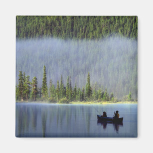 Boys fishing from canoe with mist in magnet