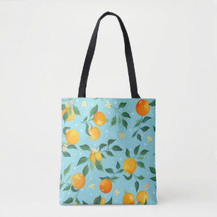 Branches of oranges with flowers on a blue backgro tote bag
