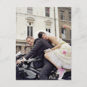 Bride and groom on motorbike, smiling, portrait postcard