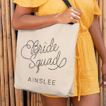 Bride Squad Modern Script Gold Wedding Name Tote Bag<br><div class="desc">This modern tote bag with a minimalist casual chic script calligraphy design reading BRIDE SQUAD as well the your custom name of your maid of honor or bridesmaid features clean lines to create a sleek and sophisticated appearance. The understated style with the little printed gold heart detail adds a touch...</div>