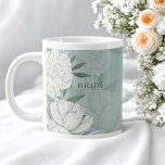 Bride Wedding Gift – Sage Green & Peonies Large Coffee Mug<br><div class="desc">Celebrate love with this elegant sage green peony bridal mug, designed as a timeless wedding keepsake for the bride. Featuring soft white peonies and botanical florals on a serene green background, it brings refined beauty to wedding mornings, engagement celebrations, and bridal showers. Crafted from high-quality ceramic with an oversized 20-ounce...</div>
