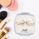 Bridesmaid bow beige cream elegant compact mirror<br><div class="desc">A beige,  cream coloured background. Decorated with a large bow.  Personalise and add your bridesmaid's name.   Black handwritten style script.</div>