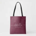 Bridesmaid Gift Burgundy Personalised Tote Bag<br><div class="desc">This Bridesmaid accessory bag features a handwritten white script typography with swashes on a burgundy background. Present your bridesmaids with a tote bag for small items traditionally presented at the rehearsal dinner,  for use in the early morning before the wedding.</div>