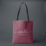 Bridesmaid Gift Burgundy Personalised Tote Bag<br><div class="desc">This Bridesmaid accessory bag features a handwritten white script typography with swashes on a burgundy background. Present your bridesmaids with a tote bag for small items traditionally presented at the rehearsal dinner,  for use in the early morning before the wedding.</div>