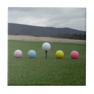 bright coloured Golf Balls on a mountain Tile