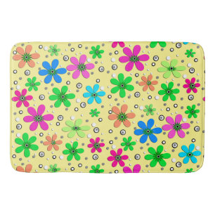 Bright multi-coloured chamomile flowers on a yello bath mat