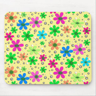 Bright multi-coloured chamomile flowers on a yello mouse mat