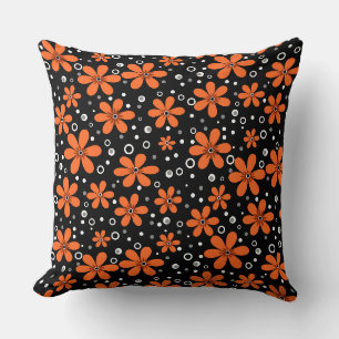 Bright orange flowers on a black background with w cushion