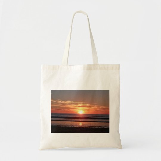 Bright orange sunny sunset seaside view tote bag