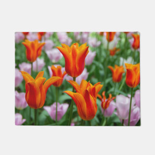 Bright orange tulips in the park doormat