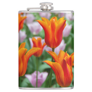 Bright orange tulips in the park hip flask