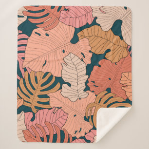 Bright pink, orange, yellow leaves of monstera and sherpa blanket