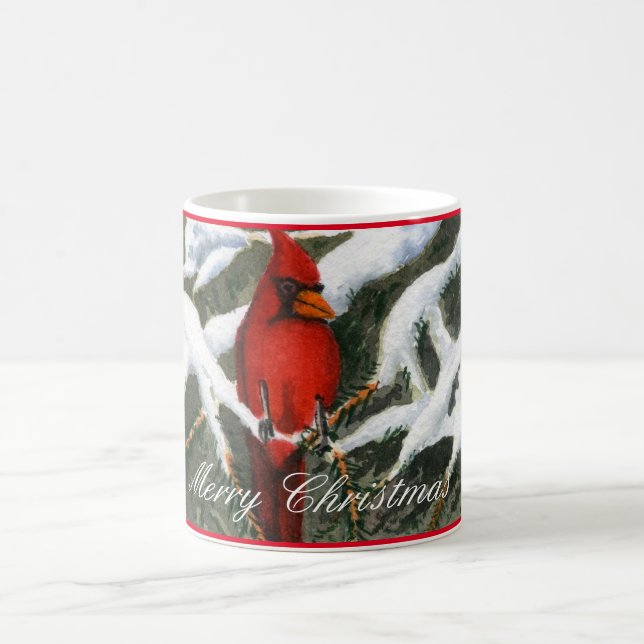 Bright red cardinal sets in a snow covered pine coffee mug (Center)