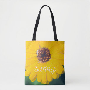 Bright yellow flower after rain tote bag