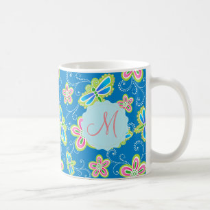 Brillant flowers, dragonflies and swirls on blue coffee mug