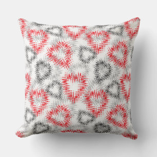 Broken hearts in red and grey on white cushion