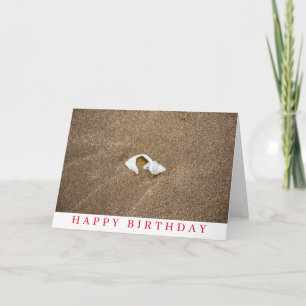 Broken shell on a sandy beach birthday card