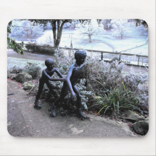 Bronze statue of children skating mouse mat
