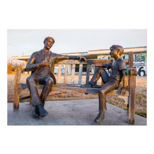Bronze statue of young and older talking photo print