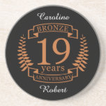 Bronze traditional wedding anniversary 19 years coaster<br><div class="desc">A design to celebrate 19 years of marriage. This design has a bronze coloured laurel design on a black background. Bronze is the traditional gift for this occasion. The text reads bronze 19 years anniversary. A romantic design to celebrate your 19th year of marriage. If you would like any help...</div>