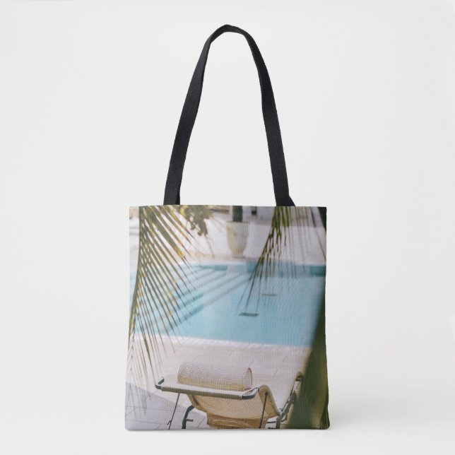 Brown and black armchair beside swimming pool in t tote bag (Front)