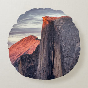BROWN AND GRAY ROCK FORMATION UNDER GRAY CLOUDS ROUND CUSHION