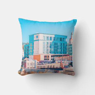 BROWN AND WHITE CONCRETE BUILDING UNDER BLUE SKY CUSHION