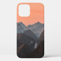 BROWN AND WHITE MOUNTAINS UNDER ORANGE SKY