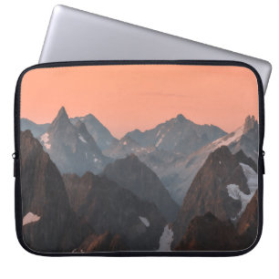 BROWN AND WHITE MOUNTAINS UNDER ORANGE SKY LAPTOP SLEEVE