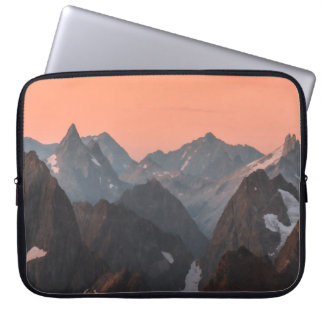 BROWN AND WHITE MOUNTAINS UNDER ORANGE SKY LAPTOP SLEEVE