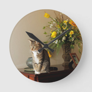 Brown black Tabby cat Sitting on piano flowers Round Clock