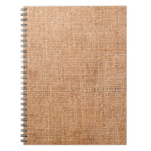 Brown burlap laying on white sheet. Abstract backg Notebook