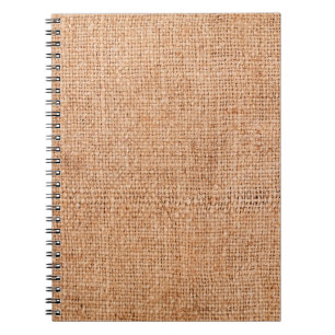 Brown burlap laying on white sheet. Abstract backg Notebook