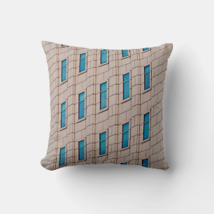 BROWN CONCRETE BUILDING DURING DAYTIME CUSHION