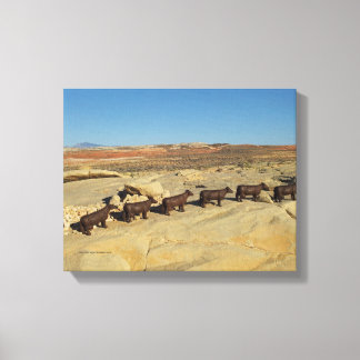 brown cows walking in desert canvas print