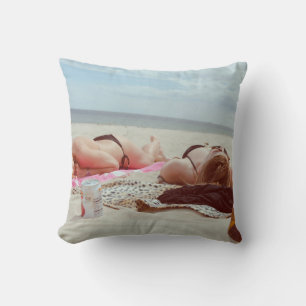 Brown glass bottle across two women cushion