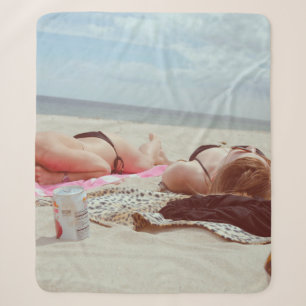 Brown glass bottle across two women sherpa blanket