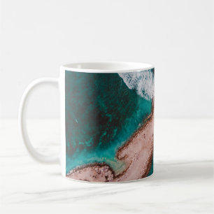 BROWN ISLAND SURROUNDED BY SEA WATER DURING DAYTIM COFFEE MUG