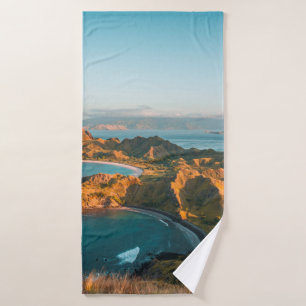 BROWN MOUNTAIN BESIDE BODY OF WATER DURING DAYTIME BATH TOWEL