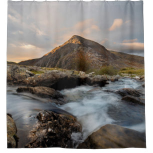 BROWN MOUNTAIN NEAR BODY OF WATER UNDER CLOUDY SKY SHOWER CURTAIN
