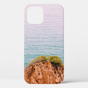 Brown rock mountain on body of water iPhone 12 case