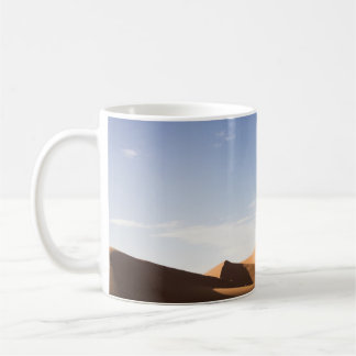 BROWN SAND UNDER BLUE SKY DURING DAYTIME COFFEE MUG