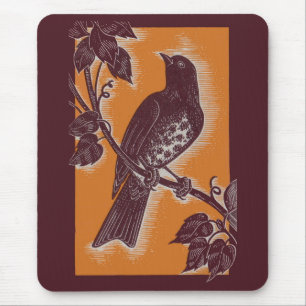 brown thrush with orange mouse mat
