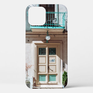 Brown wooden door on white concrete building iPhone 12 case