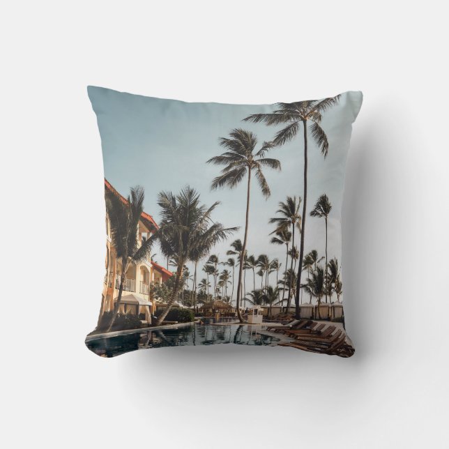 Brown wooden lounge chairs near pool surrounded by cushion (Front)