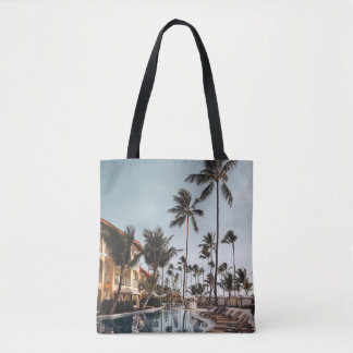 Brown wooden lounge chairs near pool surrounded by tote bag