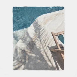 Brown wooden lounger near body of water fleece blanket